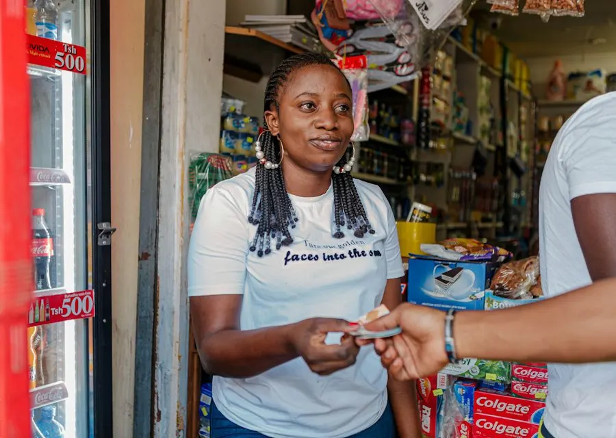 Shop owner handing an item to a paying customer